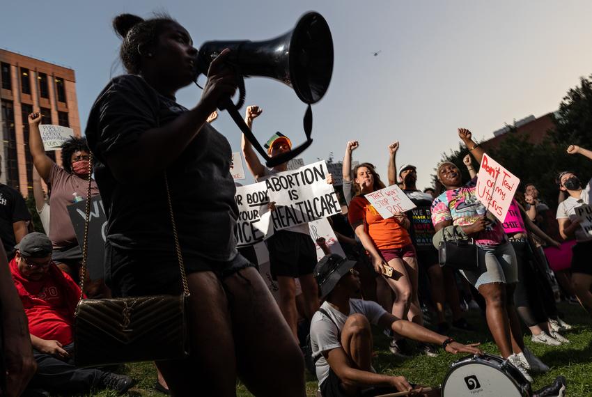 Attendees hold up their fists after a march against the overturning of Roe v. Wade, which virtually bans abortion in the state of Texas, on June 24, 2022.